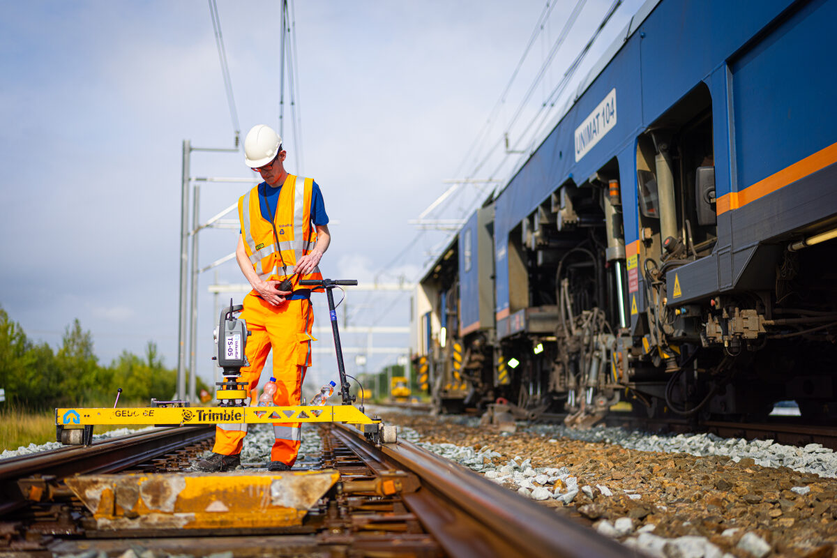 Een medewerker meet de ligging van het spoor met meetinstrumenten tijdens reguliere onderhoudswerkzaamheden aan de Hanzelijn bij Swifterbant